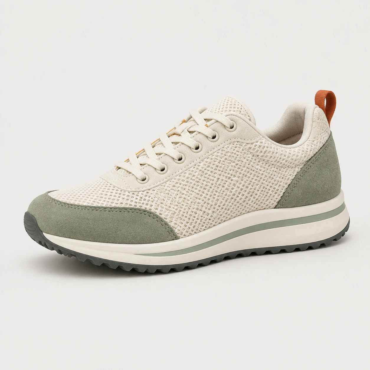 Ivory and sage sneaker on a plain studio background