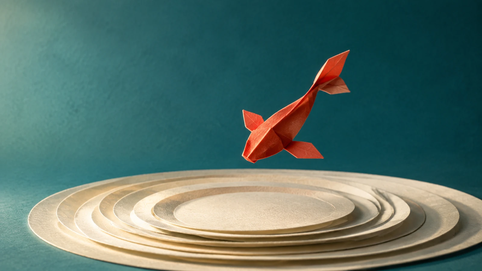 Vermilion origami fish above concentric ivory paper rings